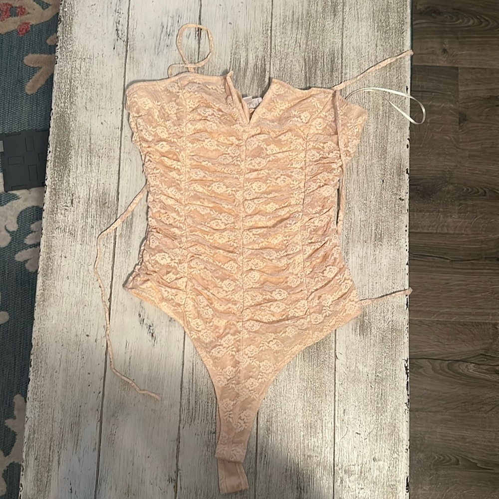 Coral/peach lace bodysuit. New without tags. Never worn. Size small